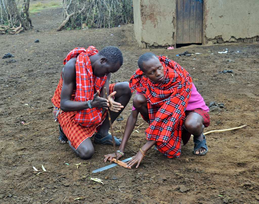 Maasai young men create fire using wood
