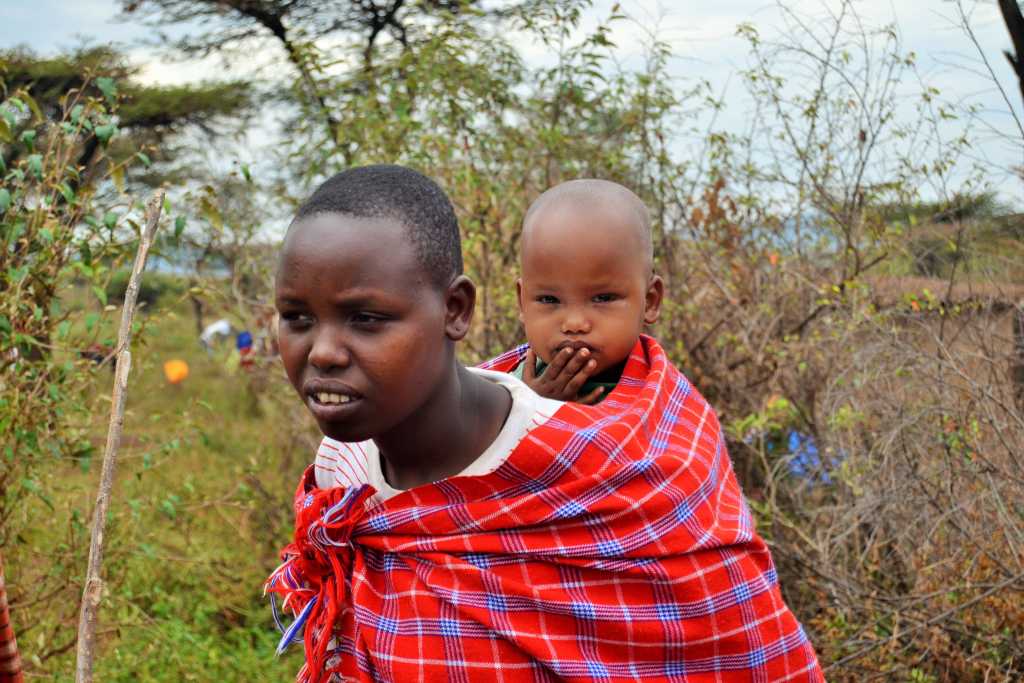 Maasai carrying a child at the back