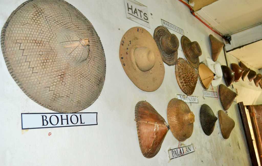 Different vigan hats and cots displayed on the wall
