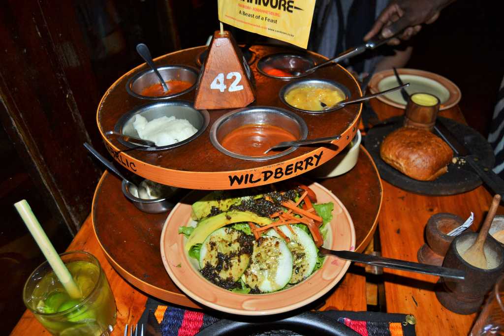 Carnivore Restaurant tiered tray vegetable salad and sauce in Kenya